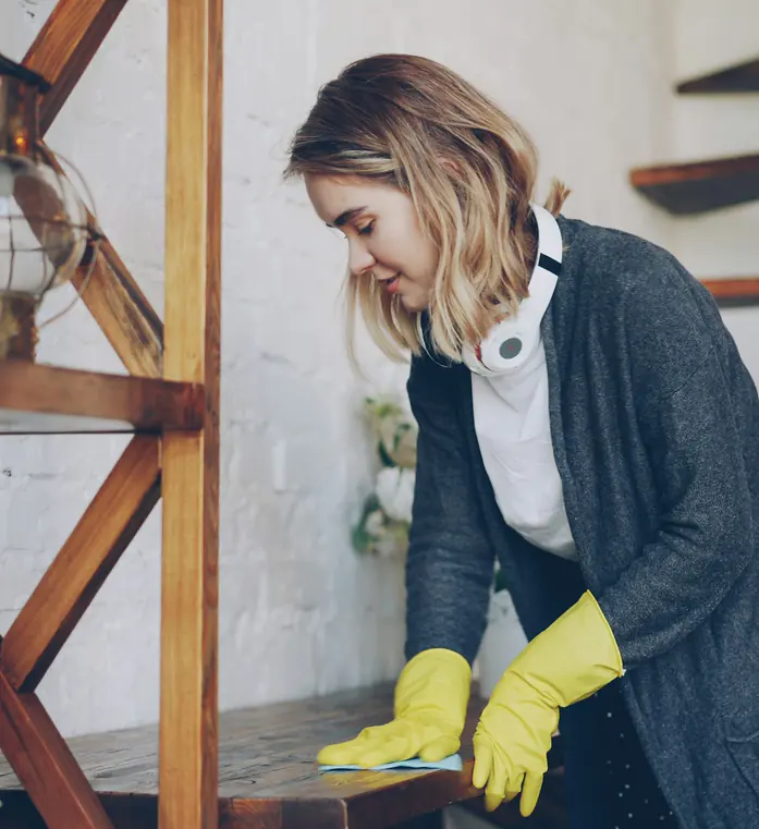 Up Services cleaner wiping down a shelf